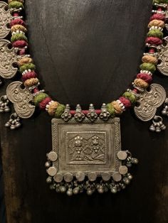 Get lost in the detail and unique beauty of antique silver Banjara beads strung onto a beautifully woven cord, handcrafted in India. All of our jewelry is one of a kind, handmade, and fair trade. A truly one of a kind piece, this necklace features the breathtaking intricacy of century old Banjara silverwork which is gracefully contrasted by the colorful and intricate woven cord they’re strung upon. The Banjara are one of the ancient nomadic tribes in India and have been known for centuries for t Traditional Handmade Beaded Necklace For Ceremonial Occasion, Traditional Handmade Necklaces For Festival, Traditional Fair Trade Beaded Necklaces For Festivals, Handmade Traditional Necklace For Festivals, Traditional One-of-a-kind Necklace For Festival, Artisan Necklaces For Traditional Ceremonies And Festivals, Handmade Ceremonial Necklaces For Festivals, Bohemian Handmade Beaded Necklaces For Traditional Ceremonies, Handmade Ceremonial Necklace For Festivals