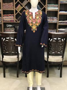 A stunningly marvellous Pheran. This Pheran features intricate Kashmir Aari embroidery on neckline and sleeves.- - - - - - - - - - - - - - - - - - - - Product Details- Condition: Brand New (made to order)- Style: Pheran Tunic- Fabric: Wool- Colour: Navy Blue- Embroidery: Aari Work- Embroidery Colour: Multi-Colour- Standard Length: 40" - Care Instructions: Dry Clean Only.**If you want the Tunic to be shorter or longer, just send us a message, and we will tailor it accordingly.Sizing- Please selec Designer V-neck Embroidered Kurta, Festive V-neck Kurta With Intricate Embroidery, Designer Embroidered V-neck Kurta, Traditional Unstitched V-neck Kurta, Traditional V-neck Chikankari Embroidery Wear, Traditional V-neck Designer Wear, Traditional Semi-stitched V-neck Wear, Semi-stitched Traditional Wear With V-neck, Semi-stitched Traditional V-neck Wear