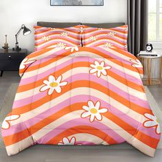 an orange and pink bed with white flowers on it