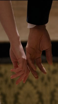 two hands holding each other in the air