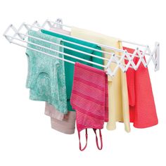 clothes hanging on a rack with towels and other items in the holder, isolated against a white background