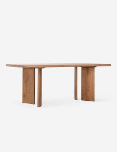 a wooden table sitting on top of a white floor