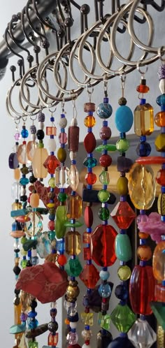 a bunch of different colored beads hanging from hooks