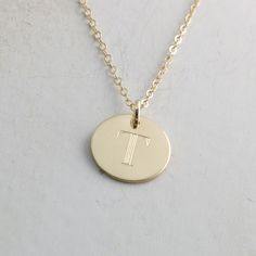 "Solid gold engraved initial necklace is a family heirloom that will be cherished and treasured for many years... it is the PERFECT gift! PICTURE IS ENLARGED TO SHOW DETAIL! SEE SECOND PICTURE FOR SIZE COMPARISON. PLEASE READ BELOW FOR ACTUAL MEASUREMENTS!! Your choice of one, two, or three solid gold 1/2\" (13mm) discs have been personalized just for you with a classy block font in a large 7mm size and it is GORGEOUS! (Font is shown in picture #6 above) The pendants hang from a solid 14k gold 1 14k Gold Engraved Initial Necklace, Classic Engraved Gold Initial Necklace, Classic Engraved Initial Necklace For Gift, Symbolic Engraved Initial Pendant Necklace, Engraved Brass Initial Pendant Necklace, Gold Engraved Necklace, Engraved Initials, Solid Gold Necklace, Initial Necklace Gold