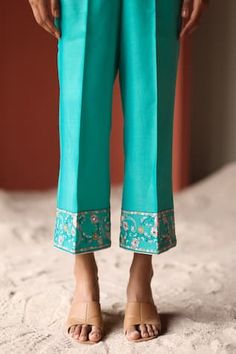 Turquoise silk chanderi jacket featuring mirror and thread embroidery with a V neck and half sleeves. Paired with wide legged pants that also feature embroidery at the hems., Fit: Relaxed Fitted Dola Silk Sets With Cutdana Detail, Semi-stitched Slub Silk Sets With Dori Work, Diwali Pant Set With Resham Embroidery, Semi-stitched, Embroidered Chanderi V-neck Sets, Embroidered Semi-stitched Slub Silk Sets, Open Jacket, Fabric Silk, Blue Silk, Pant Set