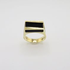 "Inventory #:  GROx-001272A Distinctive Art Deco Style 14K Yellow Gold Black Onyx Ring/ Size 11/ 8 Grams Unique onyx ring with Art Deco Design. This is a New- Never worn ring from a 1989 jewelry store close out. The 2nd picture is taken on macro for more detail Size: 11 Metal:  14K Yellow Gold Weight:  8.04 grams including stone.  There are 31.1 grams to an ounce, for reference.   Dimensions:  The ring is 7/16\" wide x 5/8\" across x 5.78mm thick and tapers in back to 4.14mm.  The dime is 1.3mm thick, for reference. Stones:  Rectangular Black Onyx 10.36mm x 15.16mm x 3.9mm thick Arrives Gift Boxed We have a generous 30 day return policy as long as it is returned in the same condition as received.  We also ship to most places worldwide." Modern Black Jewelry With Polished Finish, Modern Black Enamel Signet Ring, Modernist Black Signet Ring With Polished Finish, Modern Black Enamel Ring For Anniversary, Black Polished Signet Ring For Formal Occasions, Onyx Signet Ring With Black Enamel For Anniversary, Anniversary Onyx Signet Ring With Black Enamel, Modern Black Enamel Ring For Gift, Modern Black Enamel Rings For Formal Occasions