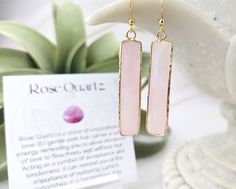 These Rose Quartz earrings are a beautiful accessory to add to any wardrobe. They feature a natural rose quartz stone in the shape of a rectangle that is hung on a Stainless Steel gold ear wire.  Rose Quartz is the stone of universal love.  It restores trust and harmony in relationships, encouraging unconditional love.  Rose Quartz purifies and opens the heart at all levels to promote love, self-love, friendship, deep inner healing and feelings of peace.  Calming and reassuring, it helps to comfort in times of grief.  Rose Quartz dispels negativity and protects against environmental pollution, replacing it with loving vibes.  It encourages self forgiveness and acceptance invoking self trust and self worth. Each pair of earrings comes with a coordinating affirmation card, with gemstone mean Rectangular Natural Stone Earrings For Gifts, Rectangular Pink Earrings For Gifts, Pink Rectangular Earrings As Gift, Pink Rectangular Earrings For Gift, Pink Rectangular Earrings For Gifts, Rectangular Rose Gold Earrings For A Gift, Wire Rose, Environmental Pollution, Rose Quartz Earrings