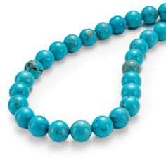 a turquoise beaded necklace on a white background