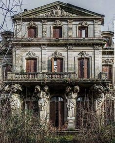 an old building with statues on the outside