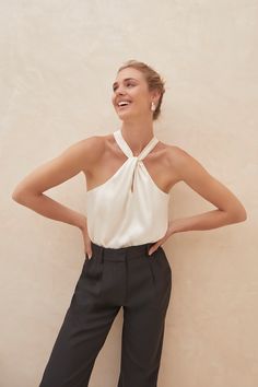 Elegant Fitted Halter Top, Elegant Halter Camisole Top For Night Out, Elegant Cami Bodysuit For Night Out, Elegant Camisole Halter Top For Night Out, Elegant Sleeveless Bodysuit With Built-in Bra, Chic Solid Backless Camisole, Elegant Halter Top With Built-in Bra For Summer, Chic White Fitted Halter Top, Fitted Cream Camisole With Built-in Bra