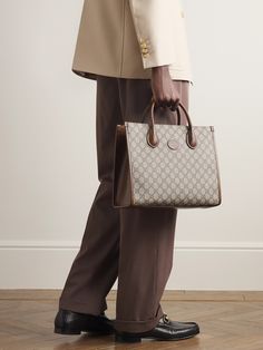 Gucci's tote bag combines the hallmarks of the 'Ophidia' collection from 2018 with the iconic 'GG Supreme' monogram from the 1930s. Made in Italy from durable coated-canvas and brown leather, it's built to hold its structured shape, fully lined in canvas and has the option of a shoulder strap or top handles. Tote Bag For Men, Gucci Collection, Gucci Tote Bag, Gucci Ophidia, Gucci Tote, Brown Coat, Gucci Accessories, Mr Porter, Fashion Advice