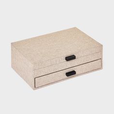 a beige box with two drawers on top