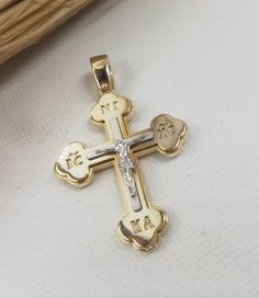 A fine quality Greek Orthodox cross in 14K with yellow and white solid gold. It's decorated to the FRONT side with jesus and a deep engaving IC XC NI KA and also the BACK side with ΚΥΡΙΕ ΕΛΕΗΣΟΝ in the middle and ΧΡ (ΧΡΙΣΤΟΣ) above and ΑΩ bellow A beautiful cross for Boys and Man. Ideal for baptism or present!  ✪ Please check the dimensions to be sure about the size! Cross Pendant Dimensions: Height - 1.50inches / 3.8 cm Width - 0,90 inches / 2.3 cm Thickness - 0.16 inches / 0,80 mm weight  -  6 Yellow Gold Cross Charms For Baptism, Yellow Gold Cross For Baptism, Greek Orthodox Cross, Orthodox Cross Necklace, Orthodox Cross, Cross Christian, Gold Cross Necklace, Beautiful Cross, Greek Orthodox