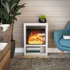 a living room with a blue chair and a fire place in the corner next to a couch