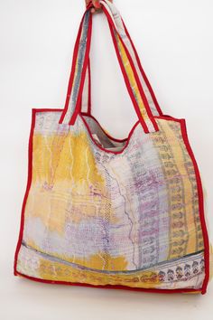 This bag is made from a vintage hand-stitched Kantha quilt. We make only 1-2 bags from each quilt and every one of them is one of a kind! Details: Shell fabric- Vintage Quilted Cotton Kantha 1. width (cm) - 40 2. height (cm)- 45 3. depth (cm) - 45 4. weight (g)- 0.400 kg 5. length of the shoulder (cm) -40 cm Care instructions: Dry clean or Hand-wash in warm water. Drip dry. How it's made: Kantha quilts are made using numerous layers of recycled silk or cotton saris which are hand-stitched in the Yellow Artisan Bags For Daily Use, Yellow Artisan Bag For Everyday Use, Artisan Yellow Bag For Everyday Use, Yellow Bohemian Rectangular Bag, Bohemian Yellow Square Bag, Yellow Rectangular Bohemian Bag, Yellow Square Bohemian Bag, Hand-stitched Tote Shoulder Bag For Daily Use, Daily Use Hand-stitched Tote Shoulder Bag