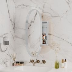 there is a bathroom with marble walls and white counter top, along with two faucets on either side of the sink