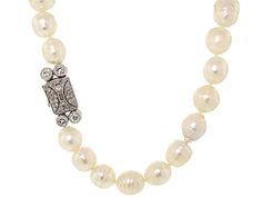 An elegant essential goes vintage vamp in this beautiful baroque pearl strand with diamond clasp. A slight graduation in size and a touch of texture in the pearls lend stylish flair while the creamy color is the height of class. The platinum clasp is a geometric delight set with pave diamonds, a single baguette and a quartet of bezel-set round diamonds. Classic Formal Pearl Necklace With Pearl Charm, Classic Single Strand Pearl Necklace For Formal Occasions, Classic Pearl Necklace With Sterling Silver Clasp For Wedding, Classic Formal Pearl Necklace With Pearl Drop, Classic Wedding Pearl Necklace With Sterling Silver Clasp, Formal Baroque Pearl Necklace With Round Beads, Elegant Pearl Necklace With Sterling Silver Clasp, Elegant Pearl Necklace With Sterling Silver Clasp For Anniversary, Elegant Single Strand Baroque Pearl Bracelet