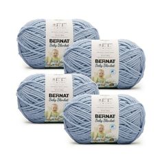 three balls of bernat yarn in light blue