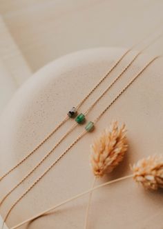 We’re in our Color Era and we’re vibing hard with these colorful stones right now. Tiny Gemma is as subtle pop - one tiny colorful stone strung on a delicate chain. 2x4mm stone is strung on a delicate cable chain. Chain measures 16". Available in Moss (African Green Jade) + Seafoam (Green Aventurine) + Ash (Black Labradorite). Available in 14kt Gold Fill + Sterling Silver. Shop the entire Gemma Collection. Handmade in Eau Claire, WI. Our jewelry is handmade so each piece will be unique and may v 14k Gold Filled Necklace For May Birthstone, Dainty 14k Gold Necklaces With Natural Stones, Dainty 14k Gold Filled Necklace For May Birthstone, Dainty 14k Gold Filled Birthstone Necklace With Delicate Chain, Dainty 14k Gold Filled Necklace With May Birthstone, Minimalist May Birthstone Necklace With Natural Stones, Minimalist Necklace With May Birthstone On Delicate Chain, Minimalist 14k Gold-filled Birthstone Necklace With Delicate Chain, Dainty 14k Gold Filled Necklace With Natural Stones