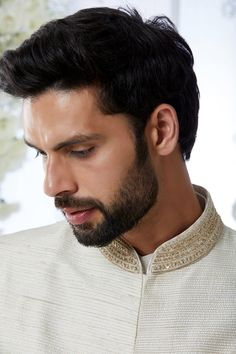 This cream sherwani set features all over gold zari embroidery on a raw silk base. It is paired with a cotton silk kurta and dhoti pants. Completing embroidered stole and footwear is also available.From Seema Gujral's Tuscan Summer collection. DELIVERY TIMEPlease allow 8-12 weeks for your outfit to arrive.FABRIC DETAILSRaw SilkProfessional cleaning only. Traditional Churidar With Gold Embroidery For Designer Wear, Raw Silk Bandhgala For Reception At Eid, Designer Gold Embroidery Kurta For Diwali, Eid Bandhgala In Raw Silk For Reception, Eid Reception Bandhgala In Raw Silk, Raw Silk Straight Kurta With Gold Embroidery, Eid Nehru Jacket With Zari Work In Raw Silk, Eid Nehru Jacket In Raw Silk With Zari Work, Reception Raw Silk Salwar Kameez With Naqshi