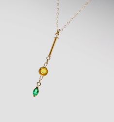 This is a truly unique and wonderful Minimalist 14k gold necklace with a 14k solid yellow gold dainty 1mm cable chain and a high quality Colombian natural emerald pendant with a natural citrine gem of great quality. The high quality natural vibrant green emerald marquise gem measures 5x3mm and is set in a solid gold bezel. The beautiful deep yellow brilliant cut round 5mm citrine is also set in a 14k solid gold light bezel and accompanies the 12mm long 14k solid gold tube that makes this necklac Minimalist Gold Emerald Necklace With Delicate Chain, Modern Emerald Jewelry In Yellow Gold, Modern Yellow Gold Emerald Jewelry, Minimalist Gold Emerald Necklace In Sterling Silver, Minimalist Gold Emerald Gemstone Necklace, Gold Emerald Birthstone Necklace In Minimalist Style, Gold Minimalist Emerald Birthstone Necklace, Minimalist Gold Emerald Birthstone Necklace, Elegant Yellow May Birthstone Jewelry