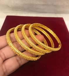 Christmas Gift, Holiday Gift,  24k gold plated Bangles, Indian Bridal Bangles, Handmade Bracelet for Women Gold Bangles for Women - Indian Bridal Bangles - Handmade Bracelet These stylish bangles feature a classic bangle design and are available in gold color. ▶ BEAUTIFUL HINGED GOLD BRACELET ▶ HIGED TO OPEN WIDE----- STAYS SECURELY SHUT -----  LIFT TAB SIDE TO OPEN Material: High quality 24k gold plated bangles ( Not solid gold) Diameter: 2.36 inches Can open Lead & Nickel free Tarnish resistan Yellow Gold Plated Bangle For Puja, Openable Gold Bangle For Festivals, Gold Plated Bangle For Puja, Heavy Gold Bangle For Diwali, Gold Round Jewelry For Puja, Round Gold Jewelry For Puja, Traditional Gold-plated Bracelet For Puja, Heavy Gold Bangle For Puja, Openable 22k Gold Bangle