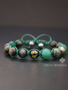 "Hand Crafted Men's Natural Stone Shamballa Bracelet made out of 10mm mixed natural stone beads - Gold Obsidian, Green Matt Polished Agate, Olive Green Malachite, Blue Tiger's Eye and Gold Pyrite, all combined with dark olive green waxed shamballa cord. As an accent the bracelet has one Agate Mala Bead carved with Tibetan Mantra \"Om Mani Padme Hum\" in the middle. The item ends with two 8mm Faceted Gray Hematite beads as stoppers. (Please, zoom the pictures for better resolution and details) No Spiritual Braided Bracelets With Round Natural Stones, Spiritual Healing Braided Bracelets With Gemstone Beads, Healing Gemstone Beads Braided Bracelets, Adjustable Rosary Bracelet For Healing With 108 Beads, Adjustable Agate Crystal Bracelet With 8mm Beads, Adjustable Agate Crystal Bracelet With Round Beads, Adjustable Green Crystal Bracelet With 108 Beads, Spiritual Gemstone Beads Braided Bracelet As Gift, Adjustable Green Rosary Bracelet With Round Beads