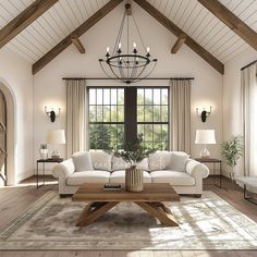 a living room with couches, tables and lamps on the floor in front of large windows