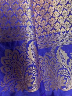 Gorgeous Statement designer Saree in Royal Blue color with Muted Gold Zari Weaving. Saree has Floral Motifs all over with design pattern borders with big flower buttas. Item : SareeColor : Royal Blue Base Fabric : Banarasi Silk Blouse material : Soft Banarasi Silk Work : Handloom Blue Anarkali Set With Traditional Drape And Pallu, Blue Chanderi Anarkali Set With Pallu, Blue Anarkali Set With Pallu In Raw Silk, Blue Raw Silk Anarkali Set For Festivals, Eid Royal Blue Cutdana Dupatta, Royal Blue Art Silk Saree With Cutdana, Royal Blue Art Silk Saree For Festive Occasions, Royal Blue Banarasi Silk Saree With Zari Work, Blue Art Silk Salwar Kameez With Cutdana