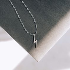 A classic, masculine, and subtle stainless steel lightning bolt necklace that will not tarnish or rust over time, even when worn in the water. 💎Free shipping on all orders💎Waterproof and non-tarnish💎Packaging that is ready to offer as a gift💎Customizable and adjustable chain length A lightning bolt necklace, a great gift for athletes, Harry Potter fans and more This lightning bolt pendant necklace is one of our best-selling necklaces. It is especially popular among athletes because it is a s Lightning Bolt Necklace, Necklace For Men, Lightning Bolt, Ladies Boutique, Men Necklace, Chain Lengths, Chain Length, Silver Color, Silver Chain