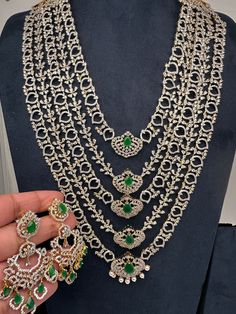 AD Diamond Finish Emerald Green Panch Five Layers Lada Long  Necklace Very pretty party wear necklace. Pair it up Sarees, Lehengas or any Party wear attire. Perfect for weddings, House warming, Half Saree Function, Baby Shower or Any Party. Necklace Length : Approx. 22 Inches; Comes with back adjustable chain. Earrings Length : 2.5 Inches; Push Back. Ready to ship from Boston, Massachusetts. Delivery time 3-5 days. If you have any questions please let me know. Thank You!! Elegant Heavy Necklaces For Party, Heavy Long Necklace For Wedding, Traditional Hand Set Diamond Necklace For Party, Traditional Hand-set Diamond Necklace For Parties, Festive Party Necklaces With 17 Jewels, Festive Party Long Necklace, Festival Long Necklace For Parties, Green Stone Work Necklace For Party, Stone Work Necklaces For Party And Festivals