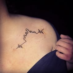 a woman's shoulder with the word mama written in cursive writing on it