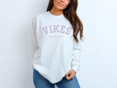 Support your team in style with our Minnesota Vikings Unisex Long Sleeve T-Shirt, crafted from 100% ring-spun cotton for ultimate comfort and durability. Whether you're cheering from the stands or watching from home, this shirt is perfect for showing off your Vikings pride. The soft, breathable fabric ensures a great fit for every fan, making it an essential addition to your game day wardrobe.  Get your Minnesota Vikings long sleeve t-shirt today and join the Skol nation in true comfort and styl Football Vikings, Vikings Shirt, Mn Vikings, Viking Shirt, Vikings Football, Hockey Shirts, Minnesota Vikings, Shirt Long Sleeve, Football Shirt