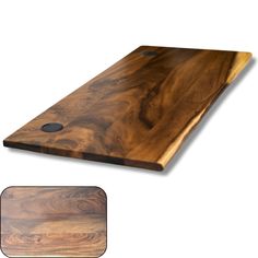 a wooden cutting board sitting on top of a white wall next to a mouse pad