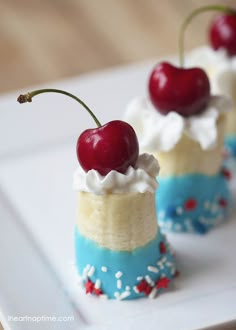 two desserts with cherries and whipped cream on them