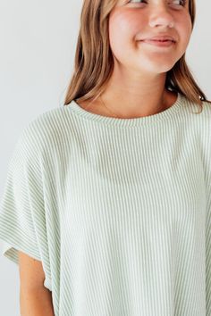 Experience comfort and style with the Journee Top. Its light green color with white stripes adds a touch of freshness, while the dolman sleeves and straight hem provide a relaxed fit. Perfect for any casual outing or lounging at home. Elevate your wardrobe with this versatile and chic top! Fits true to size. Model is wearing a small and is 5'3". Plus model is wearing a 1X and is 5'8". Size Chart Length Bust S 22" 48" M 22" 50" L 23" 48" 1x 24" 52" 2x 24" 54" 3x 25" 56" *All measurements are appr Oversized Tops With Striped Hem For Spring, Oversized Ribbed Striped Tops, Spring Oversized Top With Striped Hem, Oversized Spring Top With Striped Hem, Oversized Striped Hem Tops For Spring, Comfortable Lounging Tops For Spring, Casual Ribbed Tops For Lounging, Comfortable Ribbed Tops For Spring, Comfortable Green Summer Tops