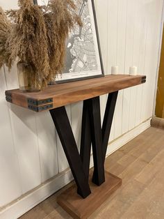 a wooden table with two black metal legs