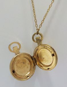 "Vintage 1928 brand pocket watch style locket pendant. 28\" chain with barrel fastener. Gold tone pocket watch style locket, including bale is 1 1/4\" x 3/4\". Hinged locket holds two photos. Gorgeous filigree design on the front of the locket & gold tone trim around the outer edge on the backside. This is in excellent vintage condition. Pre-owned & gorgeous! Signed with 1928 hang tag." Vintage Locket Necklace With Lobster Clasp, Gold Brass Pocket Watch With Antique Finish, Vintage Locket Necklace With Round Pendant, Vintage Gold Locket Necklace With Lobster Clasp, Antique Brass Gold Pocket Watch, Gold Antique Finish Brass Pocket Watch, Antique Nickel-free Locket Necklace Collectible, Antique Nickel-free Collectible Locket Necklace, Vintage Antique Gold Medallion Locket Necklace