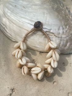 Introducing our new beach accessory: the OCEAN COWRIE SEASHELL BRACELET. Crafted with natural shells sourced from the depths of the ocean in Thailand, this statement piece beautifully captures the essence of the sea. Each shell is carefully combined to create a captivating and unique representation of oceanic beauty. Perfect for beach outfits, honeymoons, resort wear, or gift for your love ones, this choker necklace is a versatile addition to your wardrobe. What sets it apart is our commitment t Adjustable Shell Bracelets With Ocean-inspired Style, Adjustable Ocean-inspired Shell Bracelets, Bohemian Cowrie Shell Bracelet, Adjustable Bohemian Cowrie Shell, Shell Bracelet For Beach, Shell Bracelet For Beach Season, Beachy Shell Bracelet Jewelry, Shell Bracelet Jewelry For Beach, Coastal Shell Jewelry For Vacation