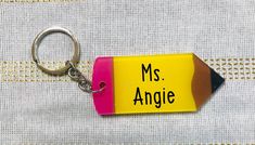 "Personalized Teacher Name Acrylic Pencil Key chain with with silver hardware. Great Teacher Appreciation Gift. Great Teacher Appreciation gift for your child's favorite teacher's keys! This listing is for ONE (1) Personalized key chain with your child's or teacher's name. Acrylic keychain measures 3\", plus approx 2\" of keychain. Design is placed using high quality permanent adhesive vinyl. Personalization will be black vinyl. Leave teacher or kid's name in personalization box Please note: The Customized Rectangular Keychains For School, Cute Customizable Craft Supplies For School, Customizable Educational Craft Supplies For School, Personalized Fun School Craft Supplies, Personalized Rectangular Craft Supplies For Gifts, Customized Multicolor Keychains For School, Cute Rectangular School Keychains, Personalized Pencil Craft Supplies For Gifts, Rectangular Multicolor Keychains For School