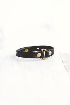 Handcrafted from lambskin leather, the Do Good bracelet features an antique brass D-ring with two large flat rivets. **Contents** * Lambskin leather, antique brass hardware * Button clasp closure * Handmade **Care/Import** * Made in the USA **Dimensions** * Adjustable to fit wrist sizes 6.5”-8” | Giving Bracelets Antique Brass Do Good Leather Bracelet at Free People in Black Adjustable Gold Leather Bracelet With Brass Hardware, Gold Leather Bracelet With Brass Hardware, Good Bracelet, Leather Bracelets Women, Bracelets Women, Antique Brass Hardware, Nice Leather, Leather Jewelry, D Ring