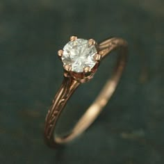 a close up of a ring with a diamond in it