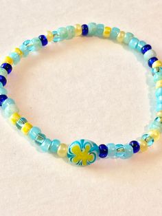 Colors: Yellow and Blue Mix Materials: Seed Beads and Elastic Stretch Cord Shipping: First class within two days of sale, excluding weekends. These bracelets come with a special millefiore bead.  I can custom make a bracelet to fit using these colors or different colors. No obligation to buy and you always will get to see the pictures of the finished product. Blue Beaded Bracelets With Heart Beads For Beach, Blue Beaded Stretch Bracelet For Summer, Blue Stretch Bracelet With Round Beads For Summer, Blue Round Beads Bracelets For Summer, Blue Heart Beads Friendship Bracelets For Beach, Summer Blue Friendship Bracelets With Letter Beads, Blue Round Beaded Bracelets For Summer, Blue Tiny Beads Stretch Bracelet For Friendship, Blue Stretch Bracelet With Spacer Beads For Friendship