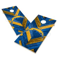 two blue and yellow cornholes with the los chargers logo on them, one is made out of wood