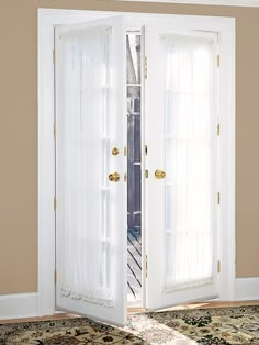 an open white door with sheer curtains on the inside and outside, in front of a carpeted area