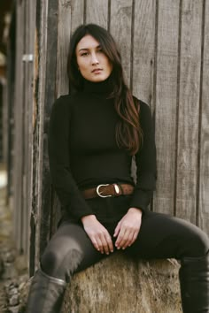 Model Tamzin Wears size XS (5’6” tall, 25” inch waist, 32b” chest, Hips - 36”) The Big Shot merino wool turtleneck is a slim fit top with button cuffs. This product is made with Merino Wool. The merino is all traceable, non mulesed and RWS certified. All of the polyester used in this yarn is recycled. A luxury wool with inherent performance enhancing qualities: Thermal-regulating, moisture wicking, antimicrobial, water repellant and soft yet durable. - 100% Merino Wool- Long sleeve with cuff - T Riding Boot Outfits, Wool Turtleneck, Slim Fit Top, Best Black, Big Shot, Equestrian Outfits, Boots Outfit, Workout Tops, Stay Warm