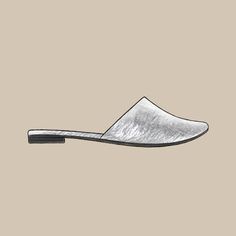 a pair of silver slippers on top of a beige background with the bottom part cut out