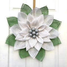 a white and green door with a large flower on it's front side,