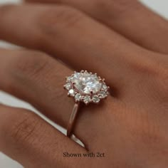 a woman's hand with a diamond ring on it