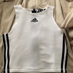 Adidas White And Black High Neck Zippered Sports Tank. Size Small. Brand New. Never Worn. Cute For An Athleisure Look. No Padding. Has Ribbing In Material. Adidas Cotton Activewear, Adidas Cotton Sporty Activewear, Spring Adidas White Activewear, White Adidas Activewear For Spring, Adidas Athleisure Activewear For Streetwear, Adidas Activewear For Streetwear In Athletic Fit, Adidas Casual Tops For Training, Adidas Athletic Fit Activewear For Streetwear, White Crew Neck Tank Top For Athleisure